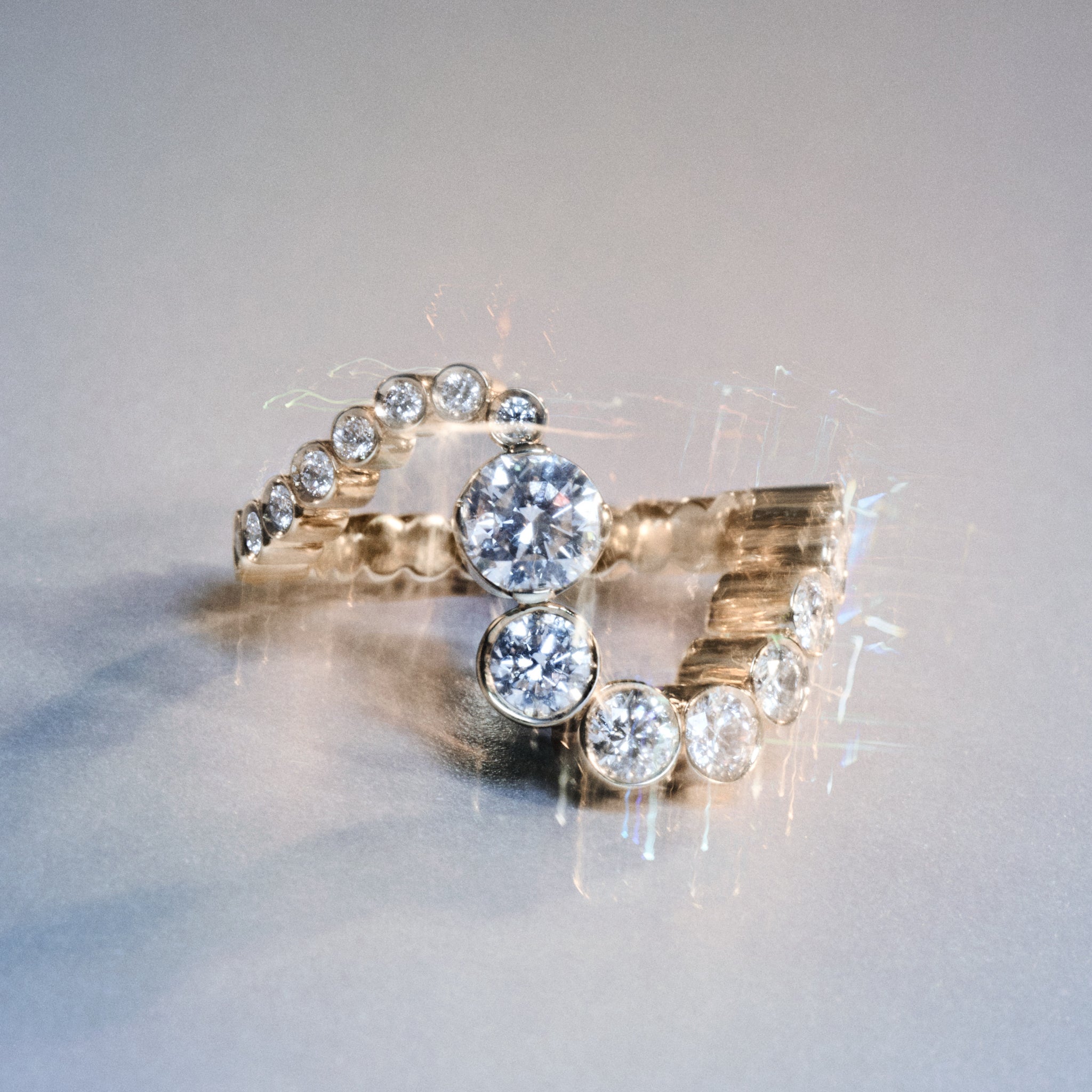 The Grand Ensemble Ocean diamond ring displayed as a still life image on a light grey background.