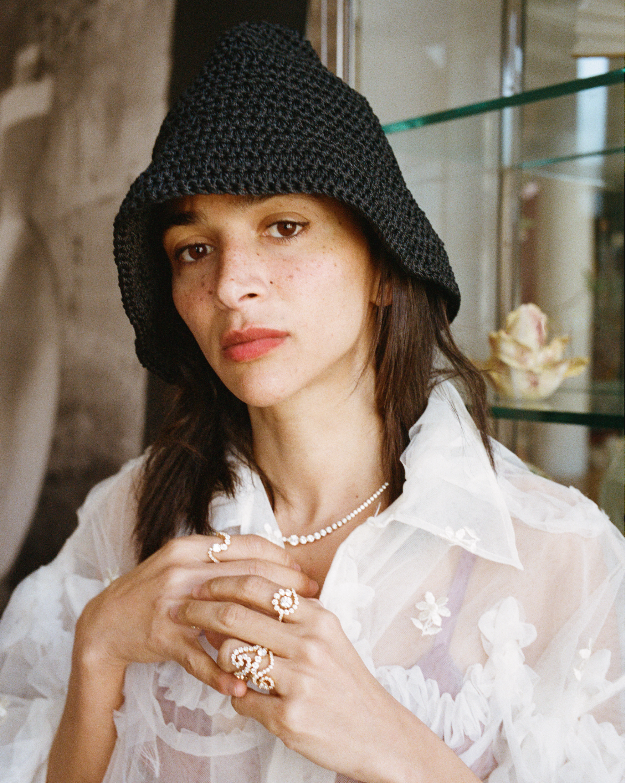 Visual artist Laila Gohar is wearing the Collier de Tennis Royal diamond necklace, and five different diamond rings playfully arranged on her fingers.