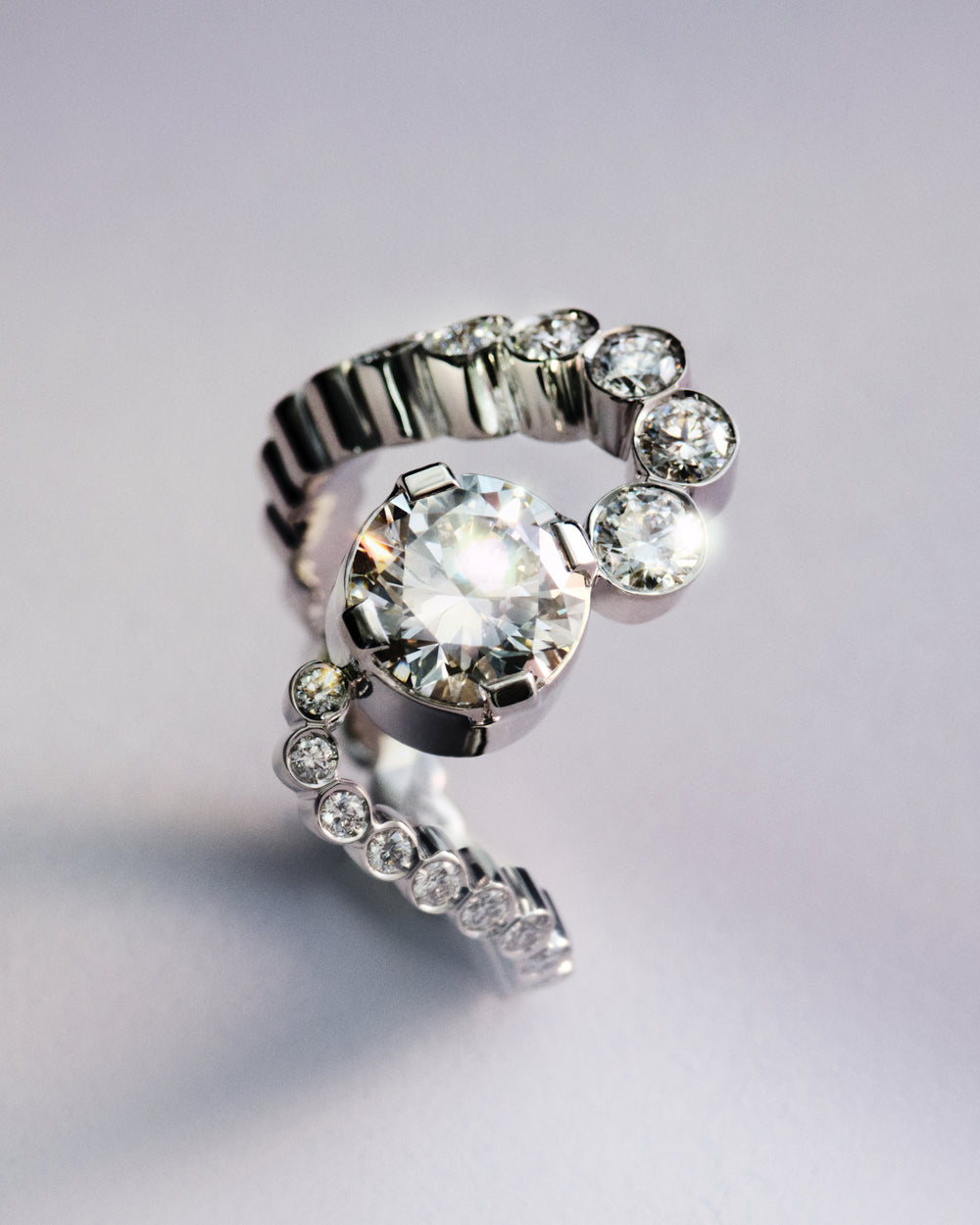 <p>The Sky 8 ring takes a more fluid approach, with a sculptural band that curves gently around the finger, balancing openness and form in quiet harmony. Inspired by Sophie Bille Brahe’s signature Grand Ensemble Ocean ring, Sky 8 evokes a wave of diamonds that wraps around the finger, rising and falling like the swell of the ocean.<br/><br/><br/>Crafted in 18K recycled white gold, the Sky 8 ring centres around a  2.01 ct round brilliant-cut diamond of G colour and VVS1 clarity, Triple Excellent (3X), and is further set with 28 round brilliant-cut diamonds of G+ colour and VVS+ clarity in closed bezel settings, bringing the total carat weight to 3.50 ct.</p>