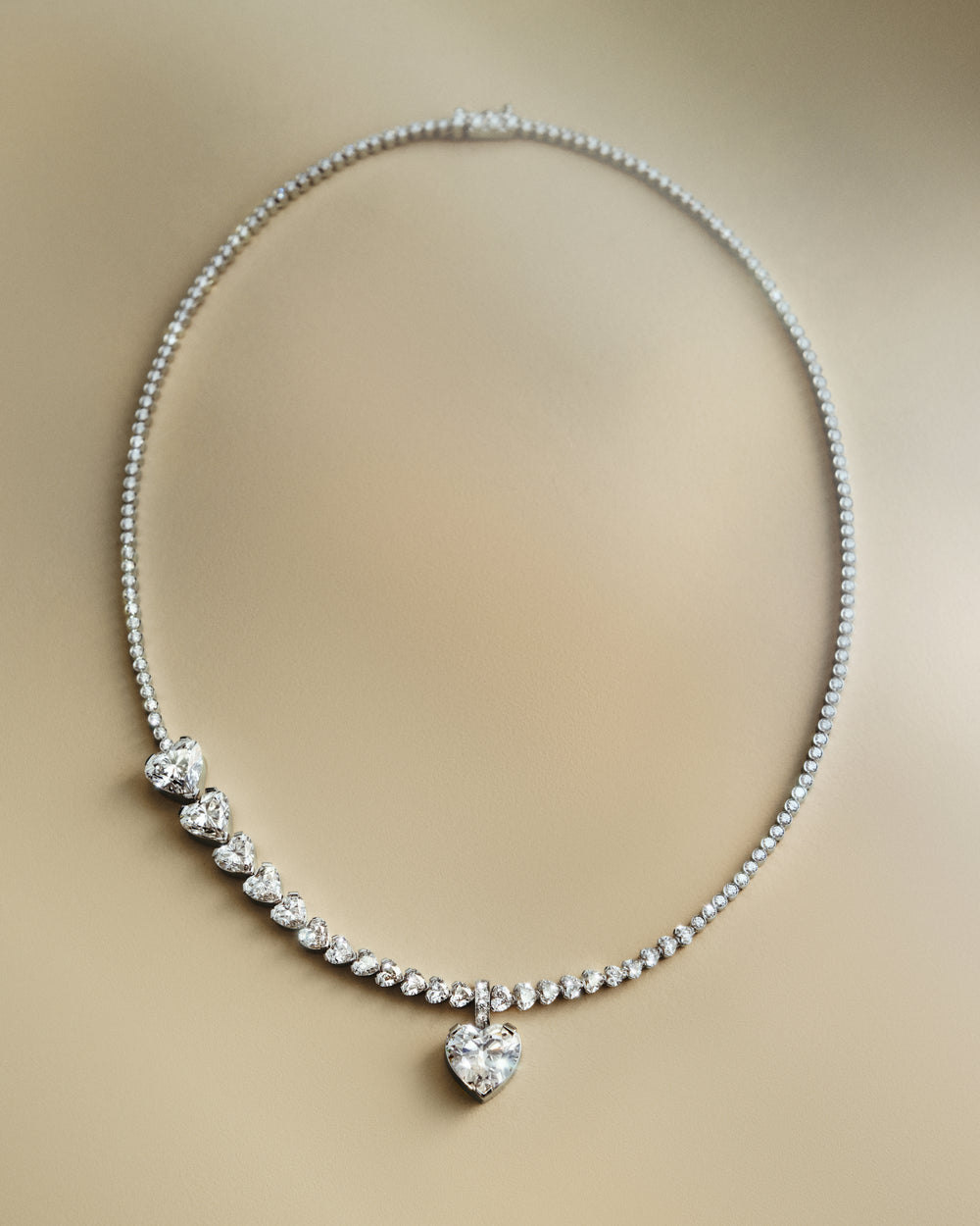 <p>The Sky 4 necklace is composed around the heart motif – a flowing line of heart-shaped diamonds that shifts in scale and rhythm. The necklace takes Sophie’s signature asymmetry as its starting point, balancing the bold and the delicate, the substantial and the fleeting, while translating the fluidity of Twombly’s paintings into jewellery.<br/><br/>Crafted in 18K white gold, the Sky 4 necklace centres around a suspended 5.13 ct heart brilliant-cut diamond of F colour and Internally Flawless(IF) clarity. The composition begins with heart brilliant-cut diamonds of 3.02 ct, 2.01 ct, and 1.00 ct, gradually unfolding into smaller heart-shaped and round diamonds that flow naturally along the body, bringing the total carat weight to 19.44 ct.</p>