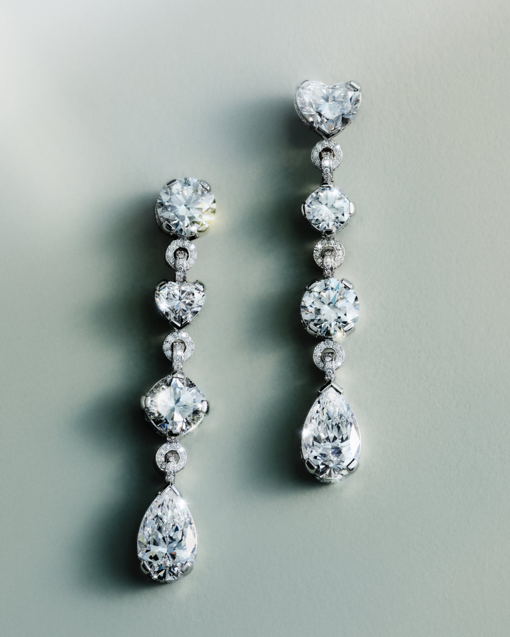 <p>The Sky 5 earrings centre around the beauty of the diamond itself. Composed through a combination of cuts and shapes, they fall lightly and asymmetrically, offering a softer and more effortless interpretation of a traditional form.<br/><br/>Crafted in 18K white gold, the earrings are composed with delicate caviar pavé settings  centred around a pair of 3.06 ct and 3.08 ct pear brilliant-cut diamonds. The 3.08 ct stone is a rare Type IIa diamond, renowned for its exceptional purity and clarity. <br/><br/>Alongside these focal stones, the earrings feature a careful selection of diamonds, including a 2.01 ct heart brilliant-cut diamond, a 2.08 ct cushion brilliant-cut diamond, two round brilliant-cut diamonds of 2.00 ct and 2.01 ct, a 1.11 ct cushion brilliant-cut, and a 1.01 ct heart brilliant-cut diamond. The earrings are further detailed with 54 round brilliant-cut diamonds set in pavé along the sides of the bezels, while the connecting jump rings are set with 386 round brilliant-cut diamonds in caviar pavé settings. The total carat weight is 19.74 ct.</p>